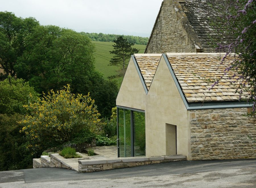 Image of a stone house overlooking picturesque green countryside.
